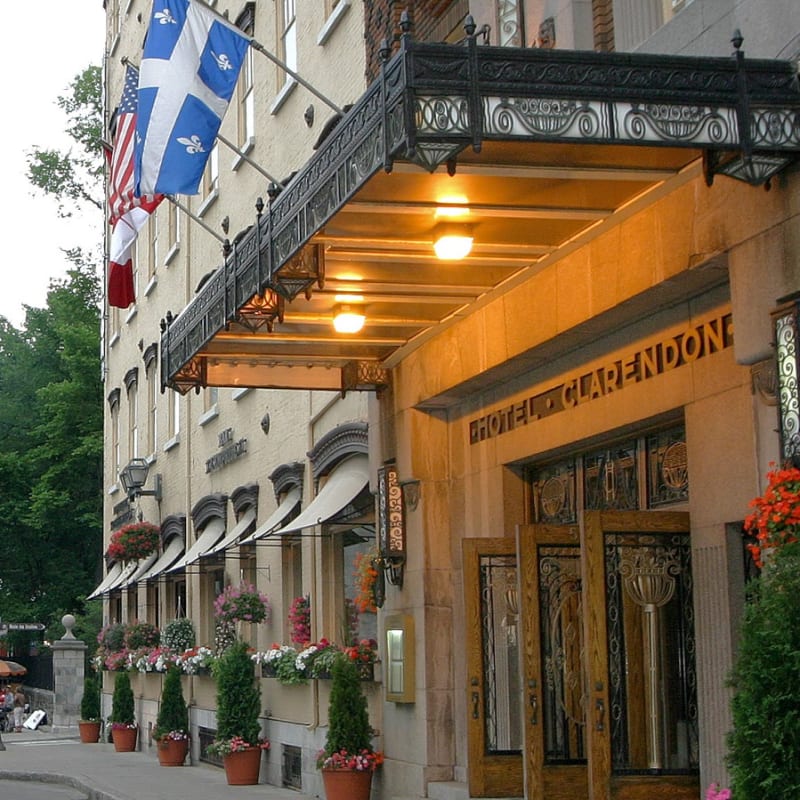 Front of Hotel Clarendon, with a horse-drawn carriage in the street.