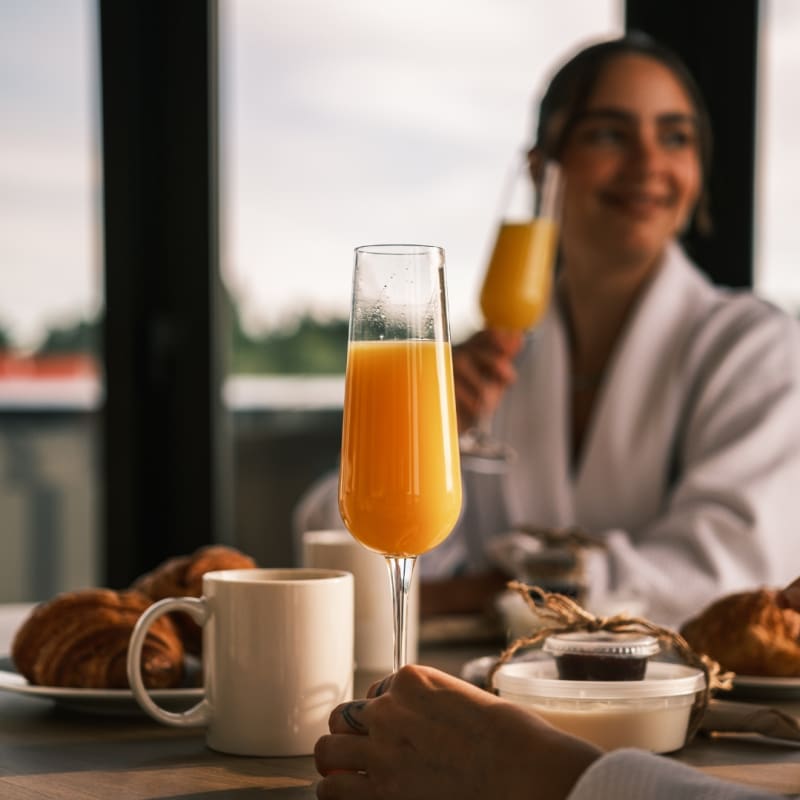 Two women having breakfast and mimosas.