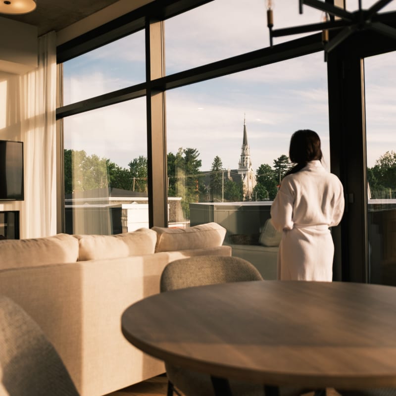 Woman wearing a bathrobe inside a condo-style lodging.