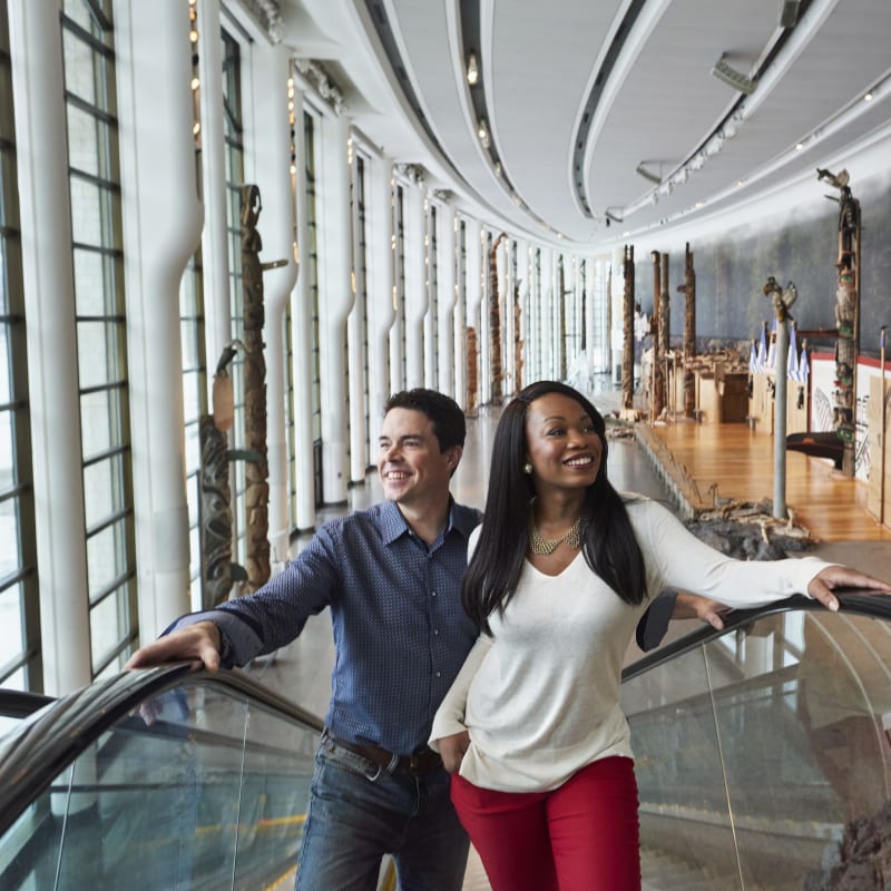 Couple on an escalator inside the Canadian History Museum.
