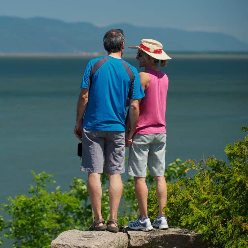 Couple watching the river after a hike.