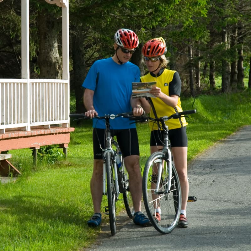 Ideas to plan your summer in Quebec - Couple on bikes checking the road.