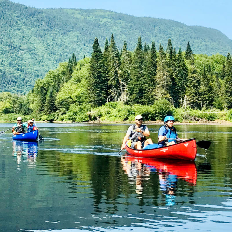 Deux couples dans deux canots sur le lac.