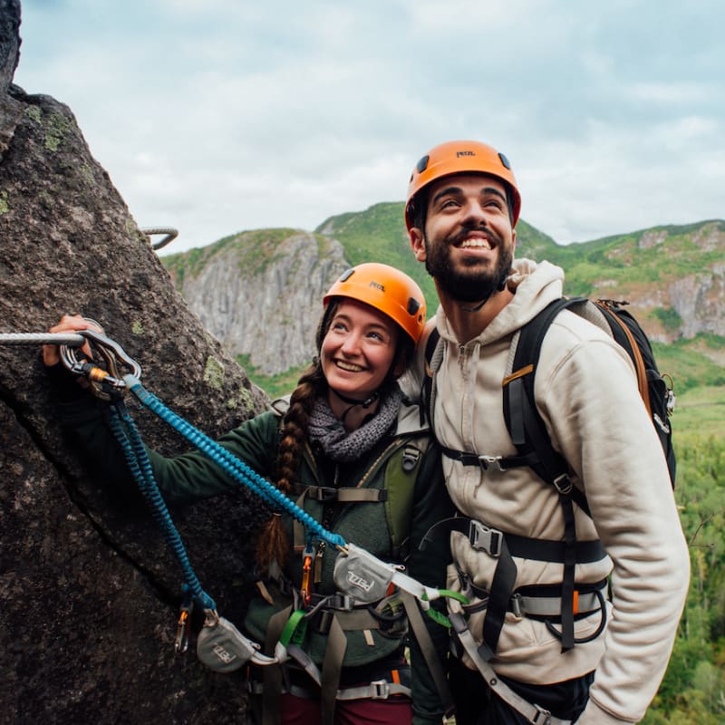 Couple heureux sur la falaise d'un parcours de via ferrata au Saguenay-Lac-Saint-Jean.
