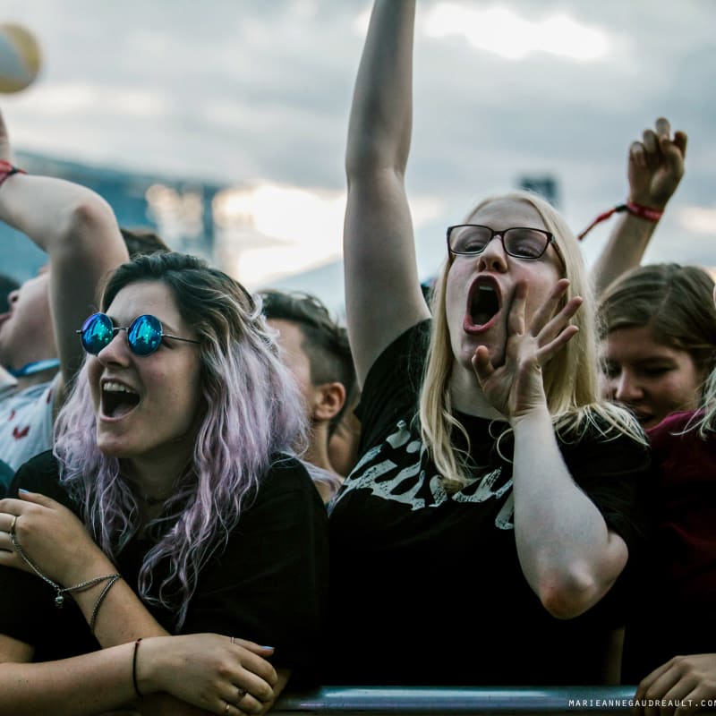 Smiling young woman in a festival crowd.