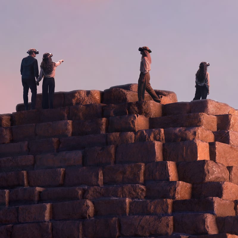People seen in an virtual reality environment at the Horizon of Khufu exhibit.