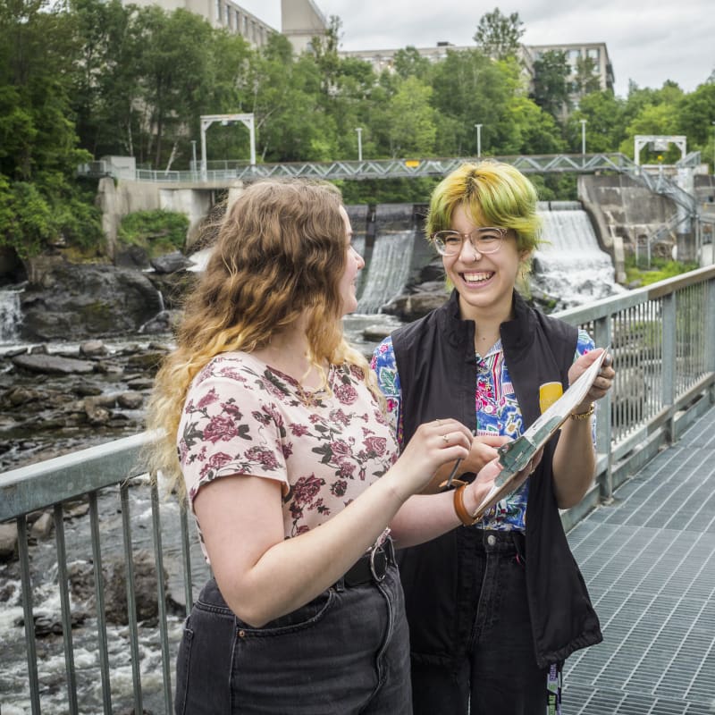 Two people participating in a creative workshop in nature.