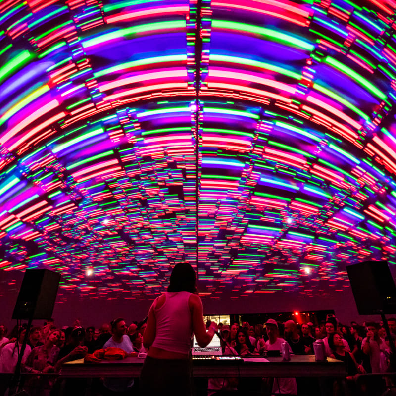 Tech music show under a colourful luminous arch