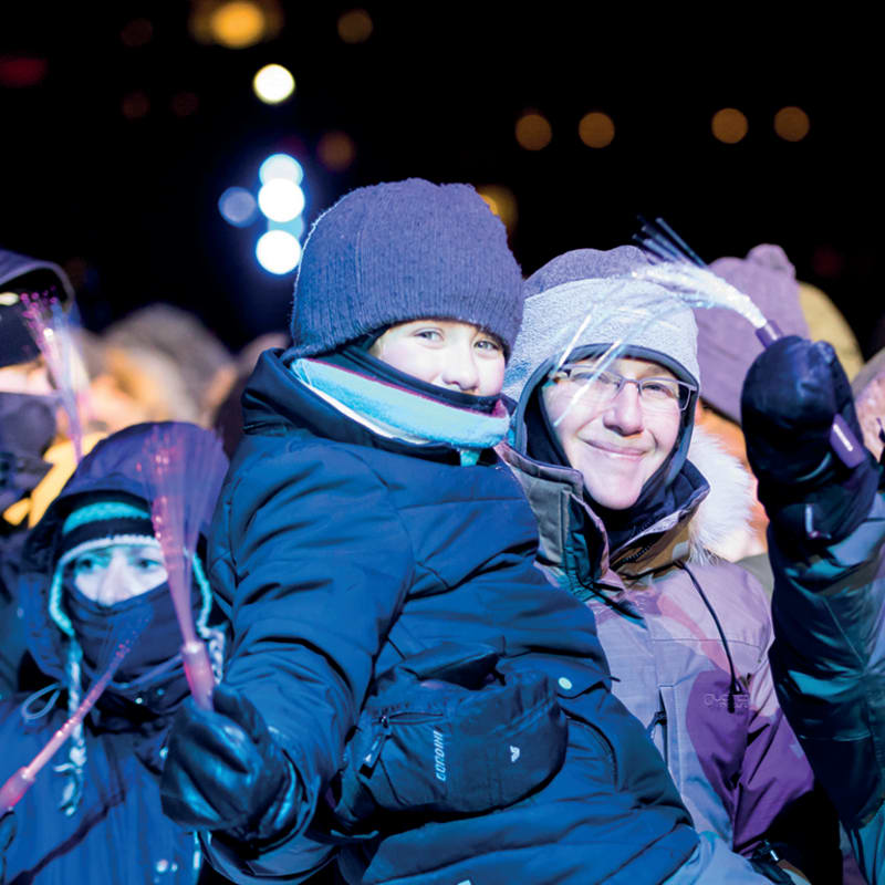 A mother and her children bundled up, ready to enjoy the celebrations.