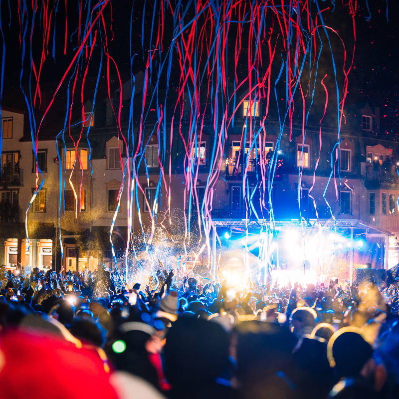 Confetti falling on a crowd gathered outdoors.