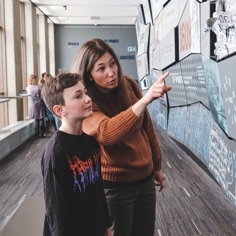 A mother and her son looking at an exhibit.