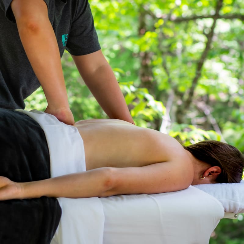 Woman getting a back massage on a massage table.