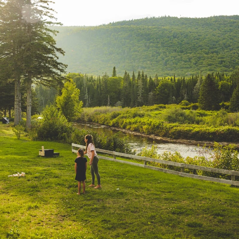 A mother and daughter in a wide-open natural landscape.
