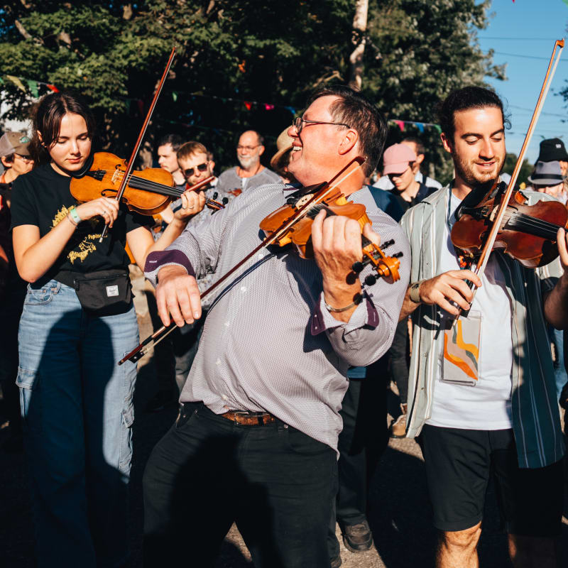 Musicians at the Ripon folk festival surrounded by a dancing audience.