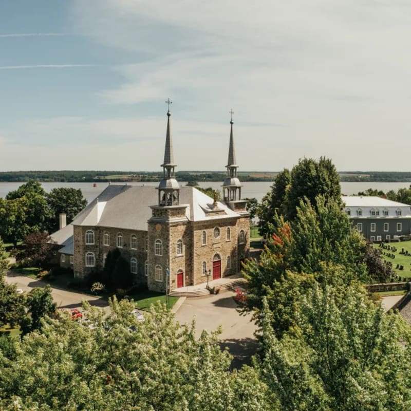 Aerial view of a church near a body of water.