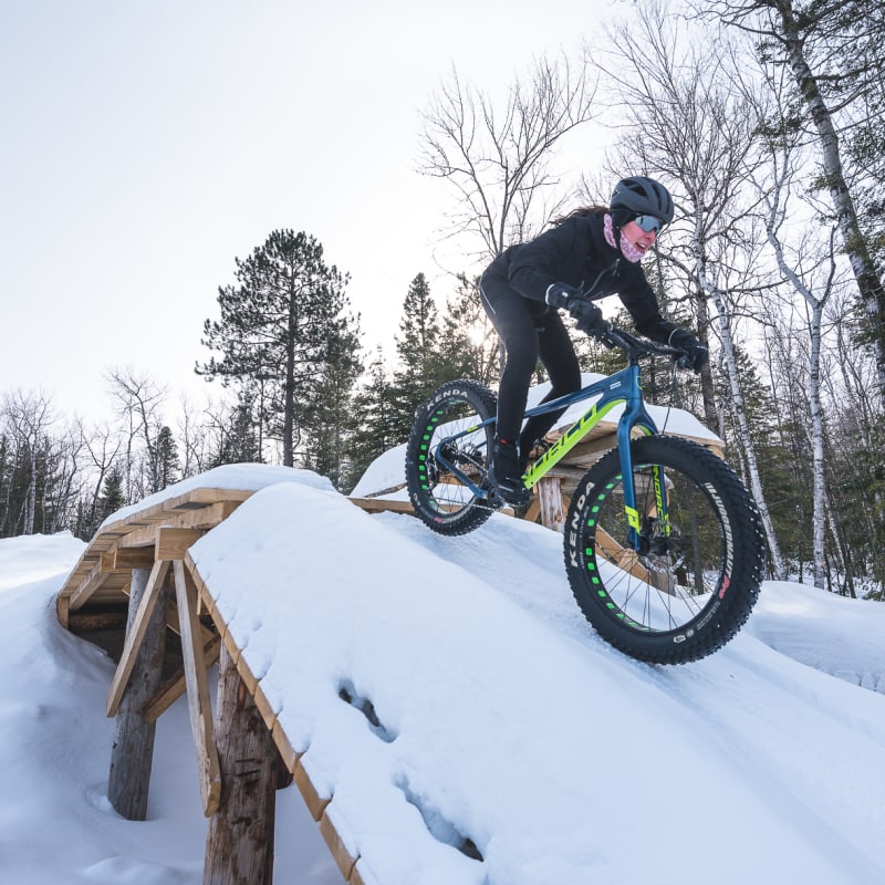 Woman riding a fatbike in the snow.