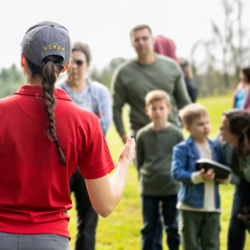 Guide giving a presentation with an owl in front of a few people.
