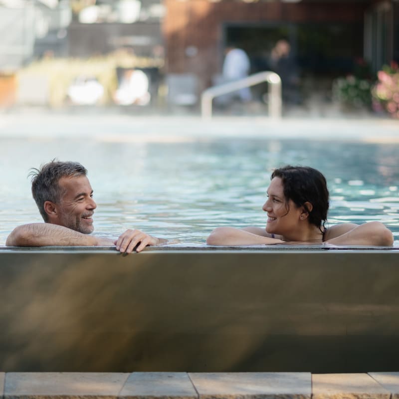 Two people soaking in a thermal pool.