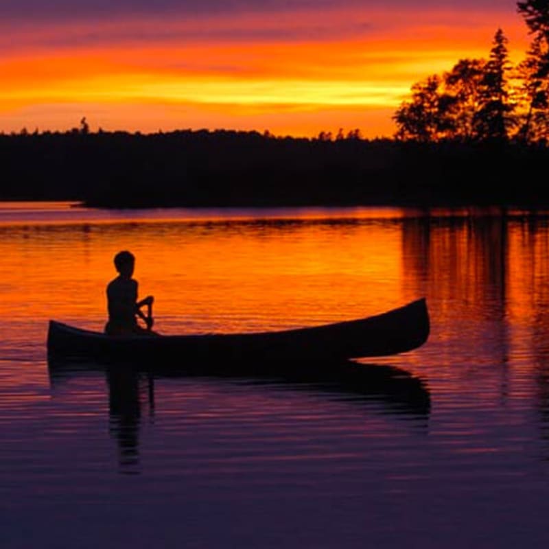 Fishing in a canoe at sunrise