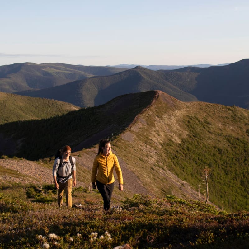 Two hikers on a mountain ridge.