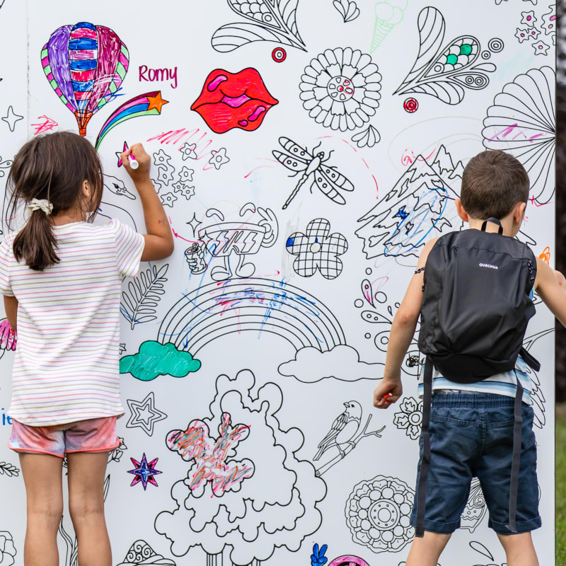 Two children drawing a mural at Oktoberfest Repentigny
