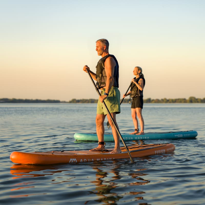 Two people paddleboarding.