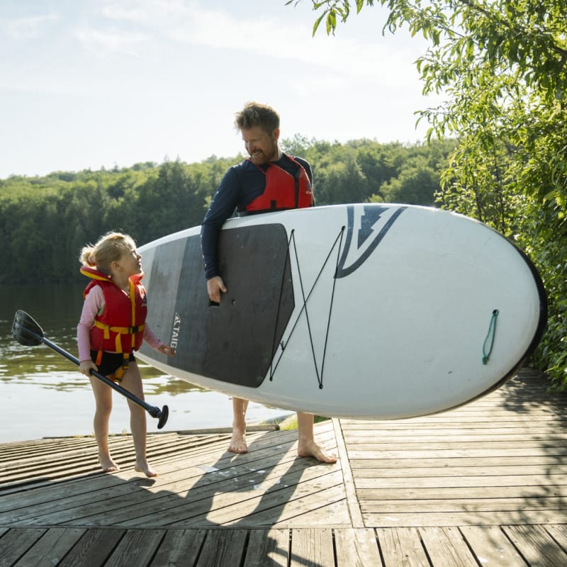 Father and daughter with a paddleboard.