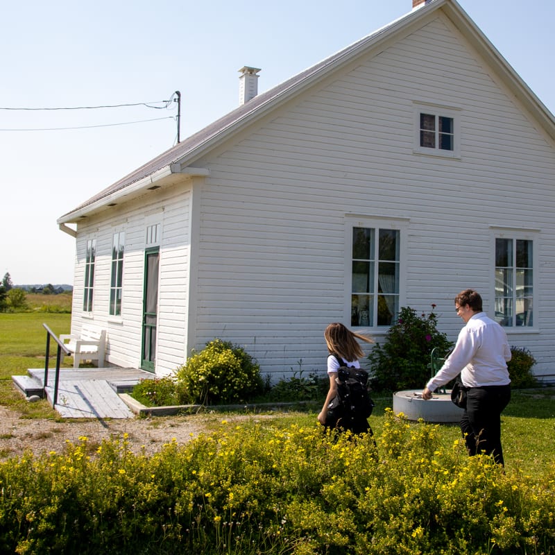 Exterior of a schoolhouse museum, a quaint little white house.