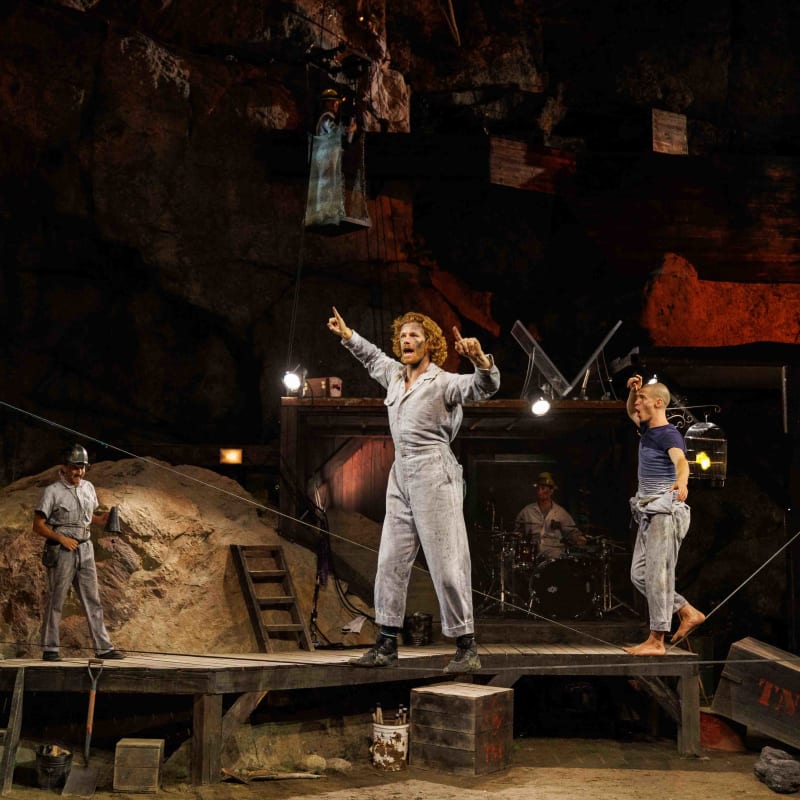 Circus performers on a stage.