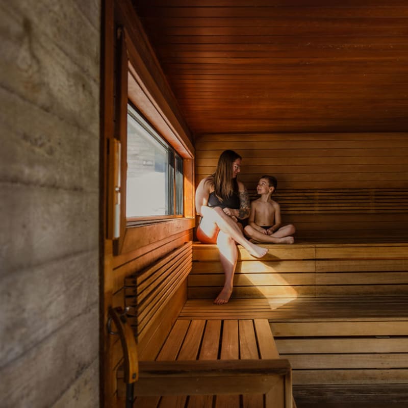 Mother and son in a sauna.