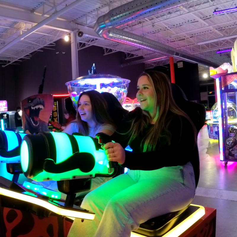 Two women playing arcades.