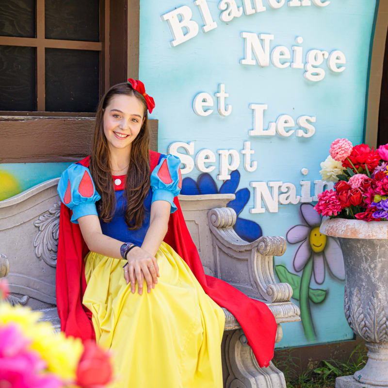 Snow White in front of her house