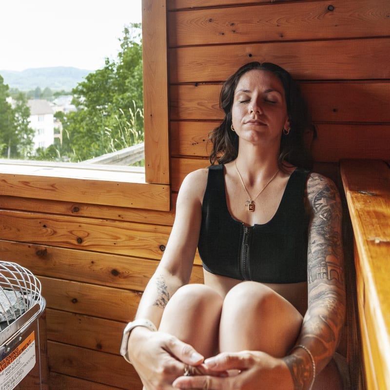 Woman in the sauna at Ax Hôtel Mont-Tremblant.
