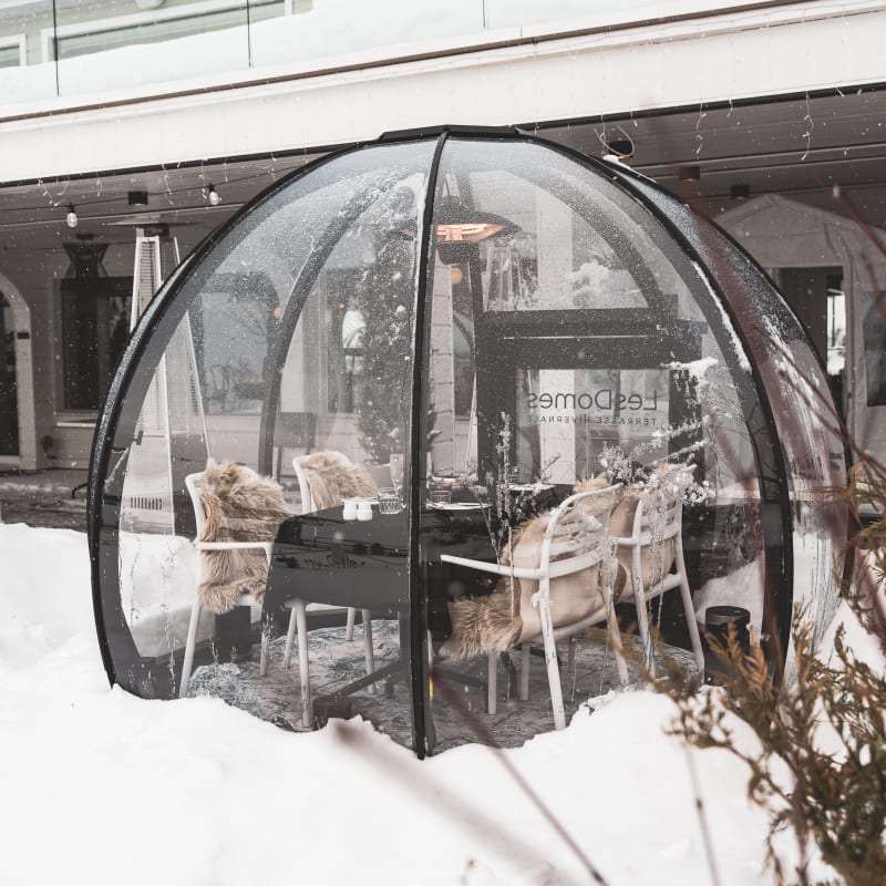 Table in a clear dome in winter at Bistro Koz.