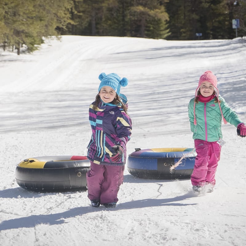 Two girls snow tubing in Charlevoix.