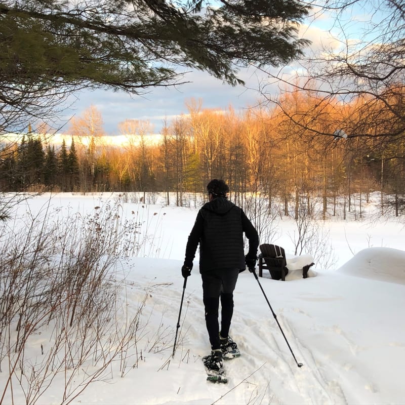 A man on snowshoes in a snowy landscape.