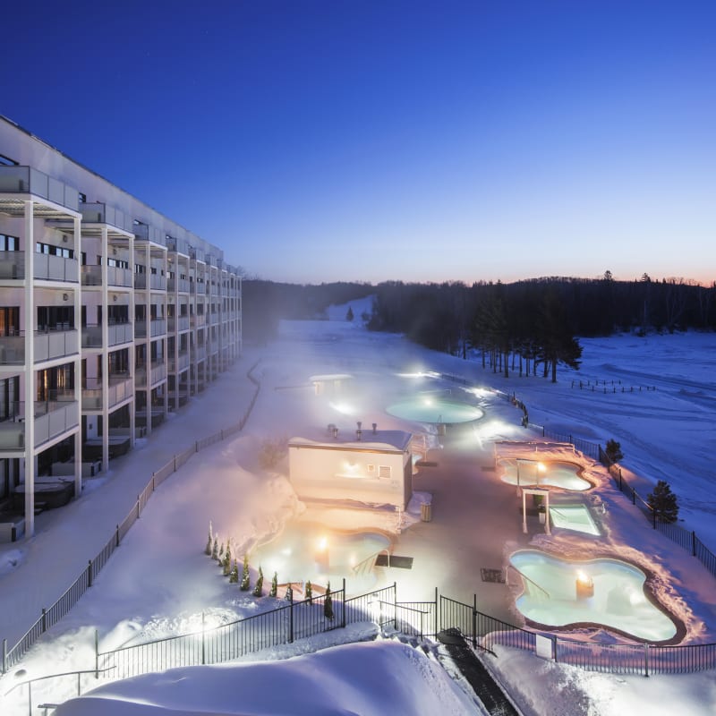 Nordic spa at Estérel Resort on a winter evening.