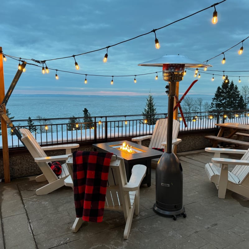Winter terrace at Manoir Richelieu, with chairs, blankets and outdoor fireplace.