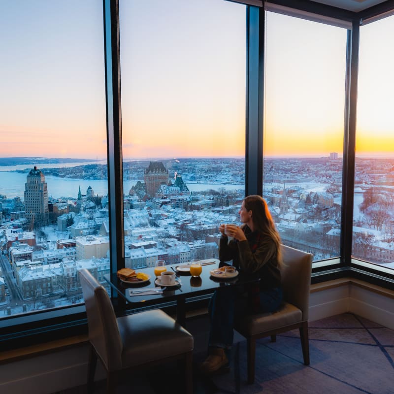 A woman working in front of windows.