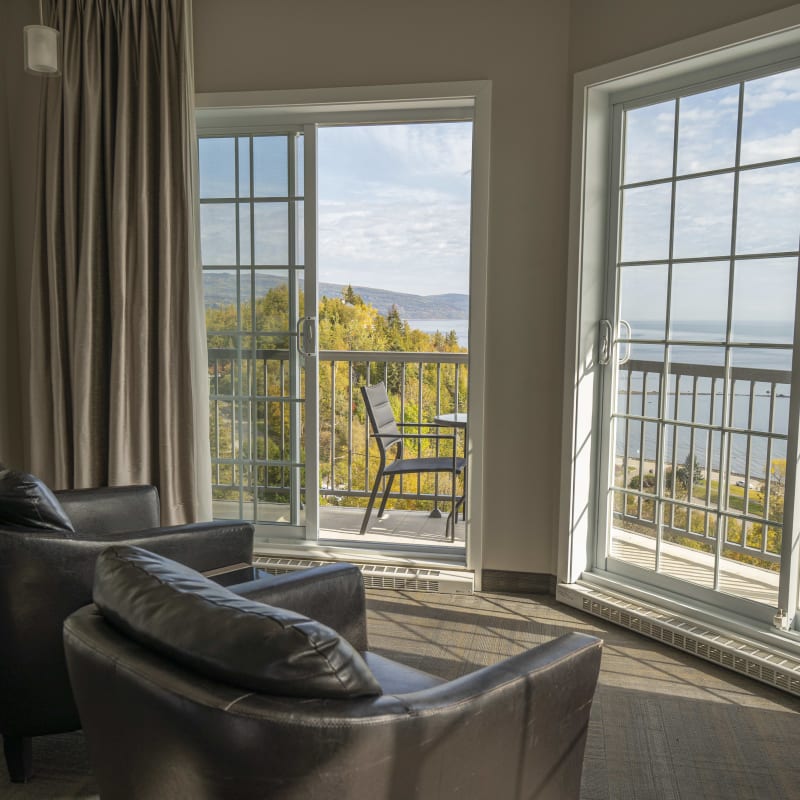 A view of the river in the fall from a room inside the building.