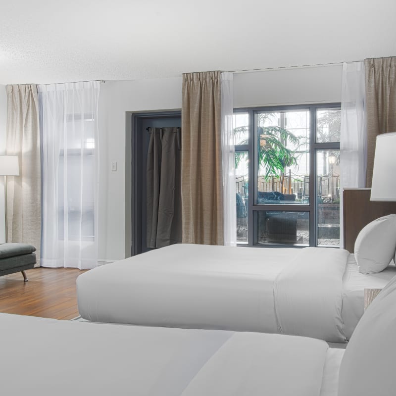 Hôtel Universel Québec - Chambre blanche avec deux lits.