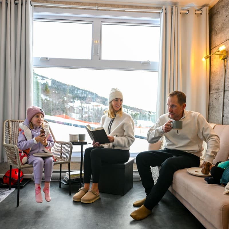 Family inside a Coolbox accommodation at Mont Grand-Fonds.