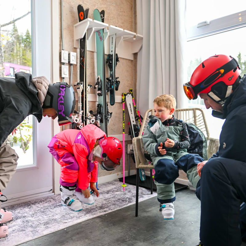 Family in a Coolbox accommodation getting dressed for skiing at Mont Grand-Fonds.