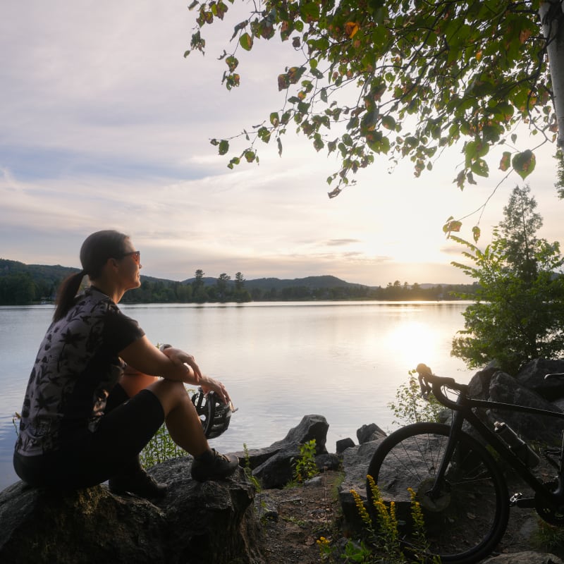 Cyclist taking a break on the P'tit train du Nord linear park.