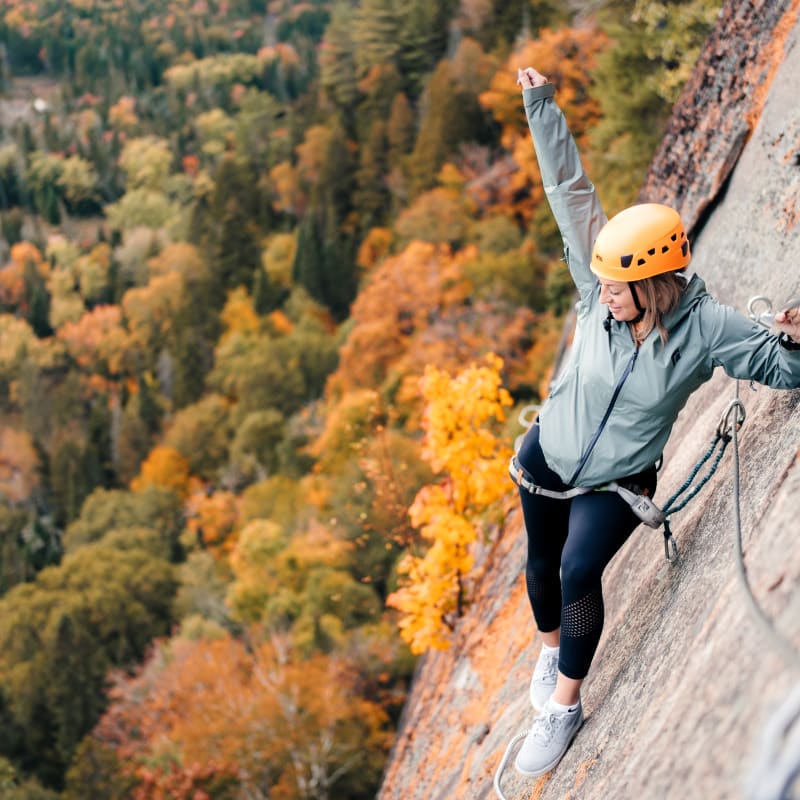 Woman on the via ferrata trail in the fall at parc national du Mont-Tremblant.