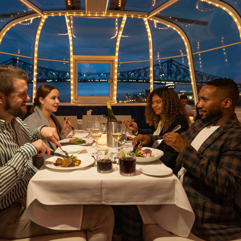 Four people seated at a table in the Bateau-Mouche
