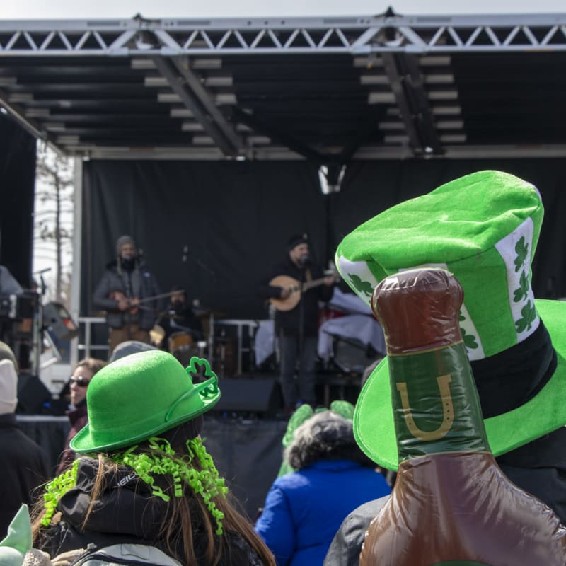 Stage and spectators wearing St Patrick's Day hats.