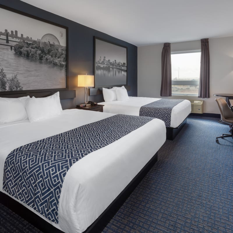 Interior of a two-bed room decorated in shades of gray.