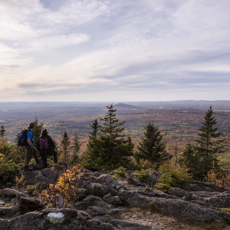 Two people on a hike in the fall in Quebec.