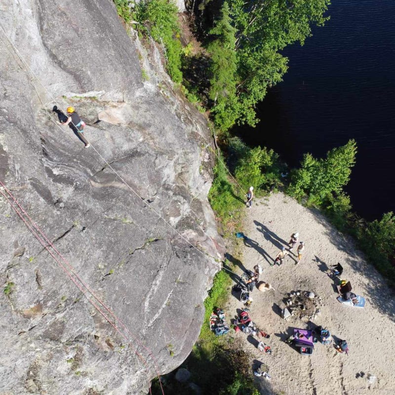 Bird's-eye view of a group of climbers at the foot of a rock face